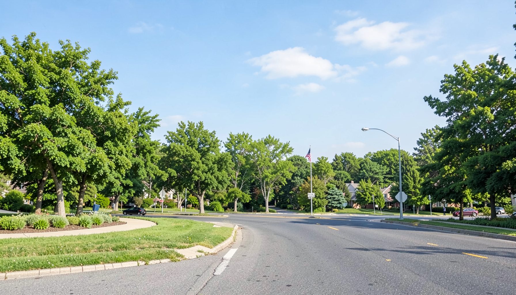A scenic New Jersey roadside view with green trees and open sky, calm and suburban.